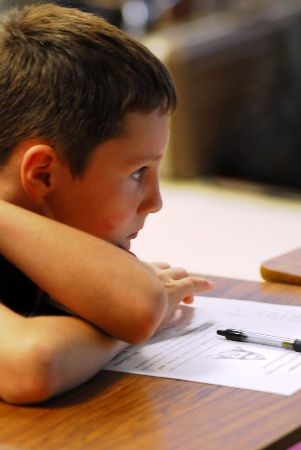 An attentive student with the bigfoot essay form. Photograph by Chris Buntenbah.