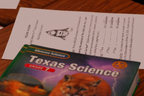 Essay contest form and science textbook. Photograph by Chris Buntenbah. 