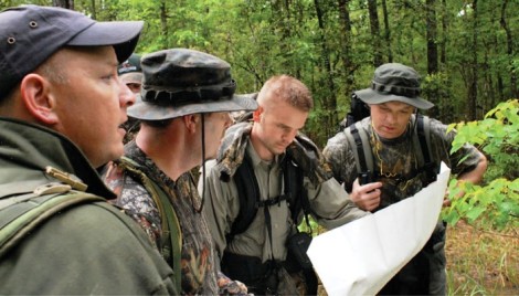 TBRC investigators Paul Bowman, from left, Daryl Colyer, Brad McAndrews and Mike Mayes get their bearings somewhere deep in the Big Thicket in April 2007. Photo: Chris Buntenbah.