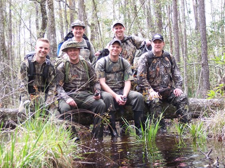 McAndrews, Colyer, Higgins, Mayes, Pinkerton and Helmer pose for a photo on a downed dry log in the swampy Area Y, March 2007.