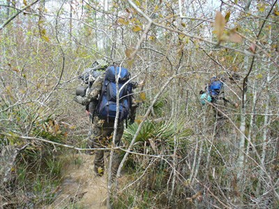 Brad McAndrews follows Ken Helmer and Alton Higgins as they attempt to bulldoze through dense thicket in Area Y, February 2007.
